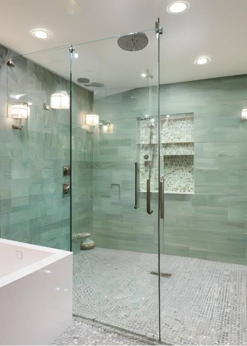 Master Bathroom Showcasing A Spacious Walk In Shower With Multiple Showerheads Glass Walls And Chic Tilework