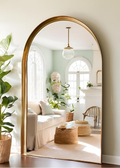Statement Mirrors Reflecting Natural Light In Spring Home Decor—a Vintage Inspired Arched Mirror Bouncing Sunlight Around The Room For An Open Airy Feel